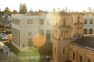 Late afternoon sun shines on the historic church and downtown of the bay area city of Alameda,...
