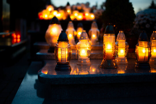 Candle Flames Illuminating On Polish Cemetery