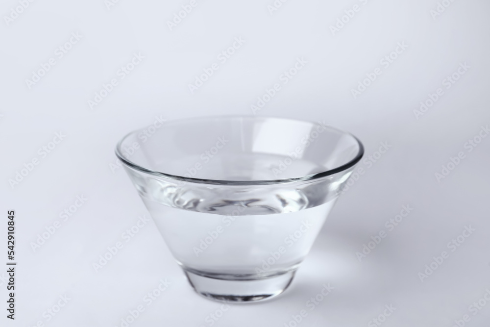 Wall mural Glass bowl full of water on white background - Wall murals