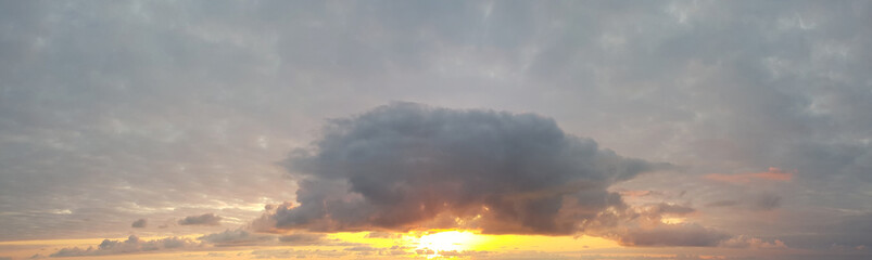 Thunder sky clouds background. Beautiful landscape with storm clouds and orange sun on sky