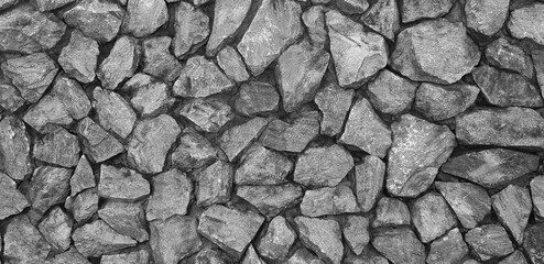 Abstract grey stone wall background in black and white tone. Art of gray rock wallpaper in monochrome style and Decoration or Exterior design in loft style concept 