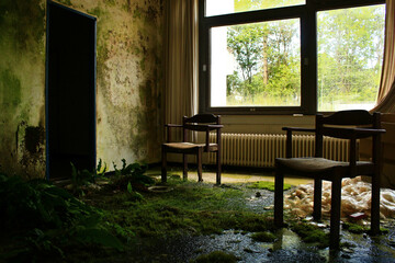 Fototapeta na wymiar Lost Place, old House, abandoned chairs in a room with moss and mould