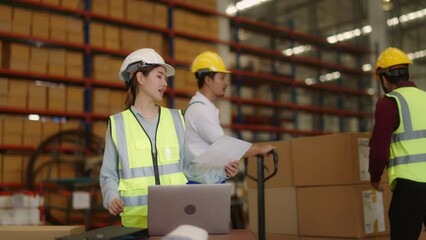 Asian Female Supervisor and male Worker Checking Scanning barcodes on boxes by tablet handheld in Distribution Logistics Center.Retail Warehouse full of Shelves with Goods in Cardboard Boxes. - Powered by Adobe