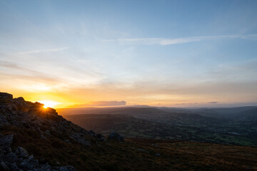 A view looking west from the top of the Blorenge mountain in Abergavenny. The sun sets in the direction of the Brecon Beacons Black Mountains which are popular for hikers, walkers and ramblers