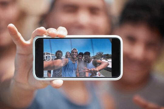 Phone, friends and selfie with a man group on a screen, posing for a photograph outdoor together. Portrait, mobile and display with a young male best friend taking a picture with his mates outside