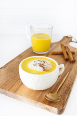 Golden milk with vegetable or cow's milk and with turmeric, cinnamon and other spices. Very aromatic, healthy and tasty drink.