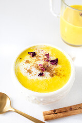 Golden milk with vegetable or cow's milk and with turmeric, cinnamon and other spices. Very aromatic, healthy and tasty drink.