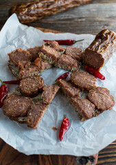 Rustic sandwich with homemade german salami on wooden table