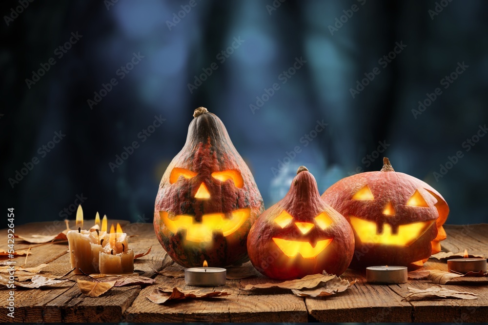 Wall mural Halloween pumpkin on desk with dark background