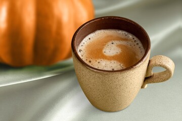 Tasty aroma latte cup and pumpkin on the desk