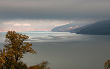 Foggy autumn morning on the Danube river with a brilliant reflection in the distance, Serbia