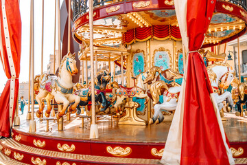 Old carousel in the park. Three horses and a plane on a traditional fair carousel. Carousel with...