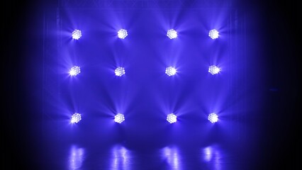 Stage blue lights shine on dark disco. Beams of spotlights illuminating an empty smoky stage in...