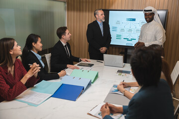 Serious diverse business team leader discuss financial paperwork, Smart businessman and businesswoman partner teamwork talking discussion in group meeting at office table in modern office interior