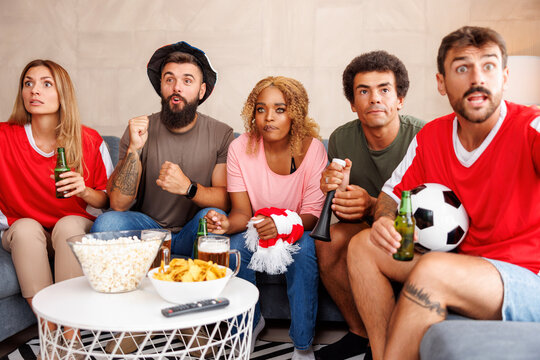 Friends tense while watching football on TV