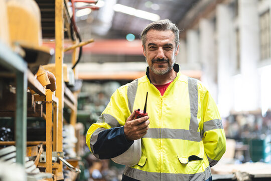 professional technician engineer with safety hard hat working to maintenance construction equipment in industrial factory, inspection man having manufacturing occupation job of production technology