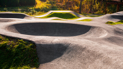 Outdoor bicycle asphalt pumptrack surrounded by nature in Polanka Wielka, Poland. - obrazy, fototapety, plakaty