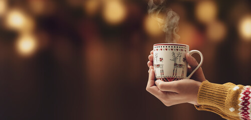 Woman having a hot chocolate in a Christmas cup