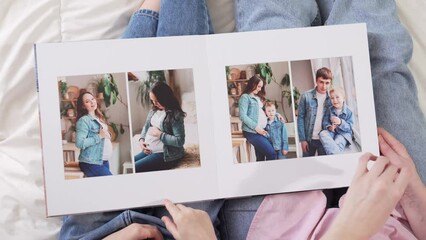 top view. pages of a photobook with photos of a pregnancy family photo shoot