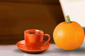 Tasty aroma latte cup and pumpkin on the desk