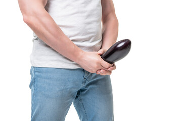 Man crop view holding eggplant at crotch level imitating erect penis isolated on white