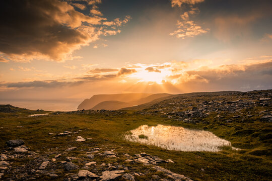Midnight sun rising over Knivskjellodden, a trail in the tundra towards the true northernmost point of Europe,  Norway