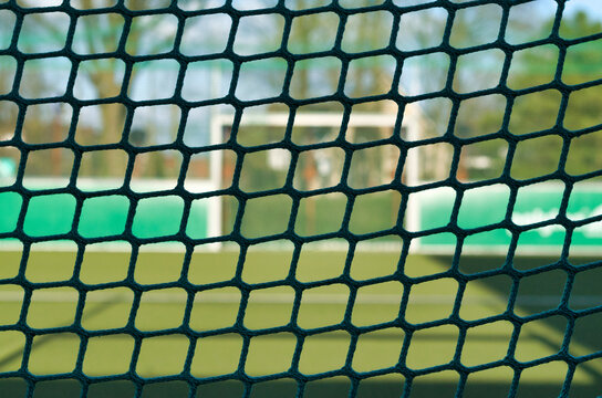 fine-meshed football goal net on a small field