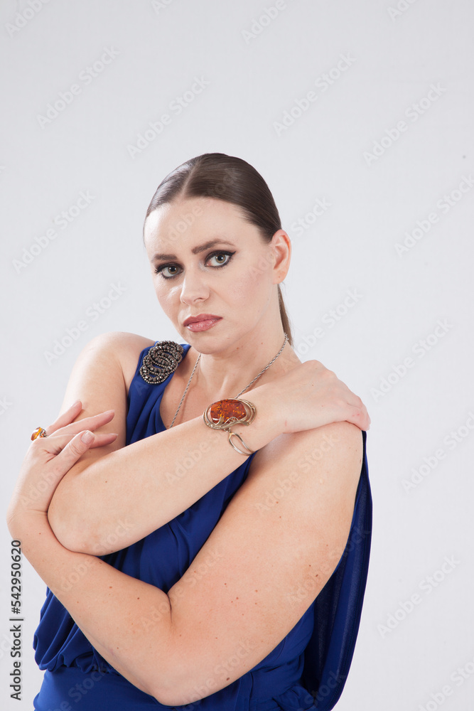 Wall mural beautiful woman in a blue dress looking thoughtful