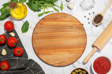 White culinary background with wooden board and pizza ingredients.