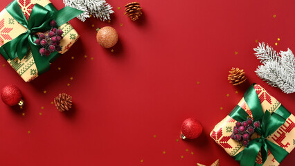 Christmas greeting card template. Vintage Christmas gifts, baubles, fir branches, cones on red background.