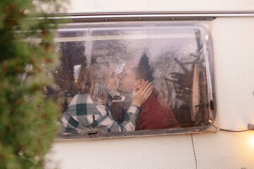 couple kissing .window in winter. christmas tree