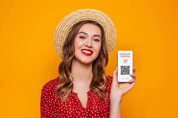 young woman holding a mobile phone with a discount coupon and a qr code