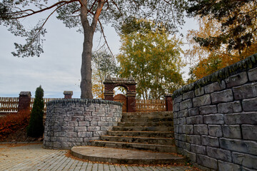 View of the stone staircase with a parapet in the park.