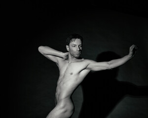 Young attractive guy posing in the studio. Beautiful body.