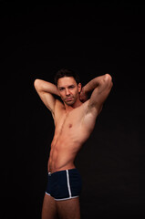 Fototapeta premium Young attractive guy posing in the studio. Beautiful body.