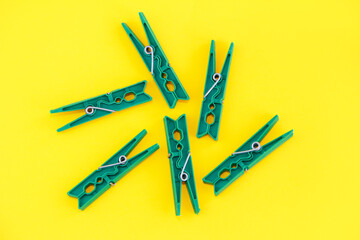 plastic clothespins for fastening laundry on a rope, isolate on a yellow background