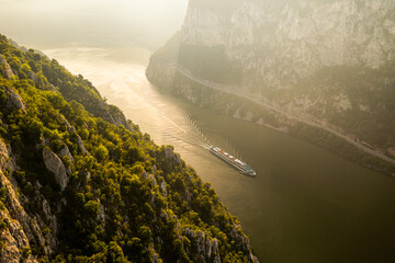 Cruise ship on Danube river. Aerial view of a cruising boat with tourists traveling to explore...