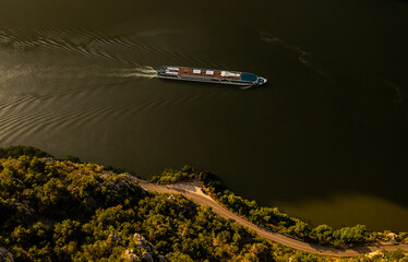 Cruise ship on Danube river. Aerial view of a cruising boat with tourists traveling to explore Europe on Danube river.