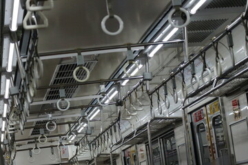 The hand handle or handgrips or handrails of commuter line passengers swaying due to the movement of the train.