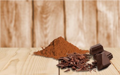 Cocoa aroma powder and chocolate on the desk