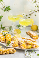Traditional French dessert eclairs with lemon curd topping. Limoncello italian lemon liqueur, Restaurant menu, dieting, cookbook recipe top view
