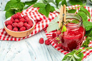 raspberry jam on a white wooden background. Raspberry in bowl. Organic Raspberry. Red berry. banner, menu, recipe place for text, top view