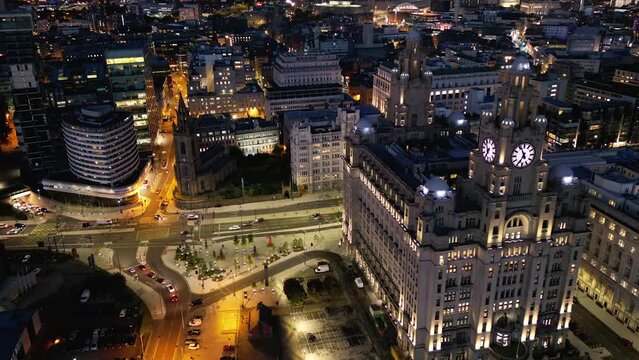 Time lapse aerial view of Liverpool Liver Building and city traffic at night, Merseyside, England