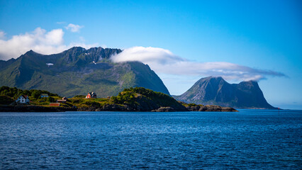 panorama of the coast of the island of senja in norway  turquoise water and mighty mountains in northern norway © Jakub