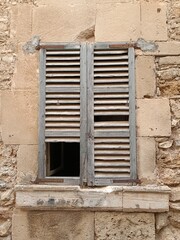 Old wooden shutters on the window in the wall