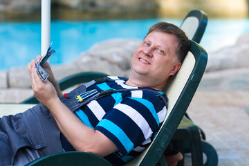 A worker with money in his hands lies resting after hard work.