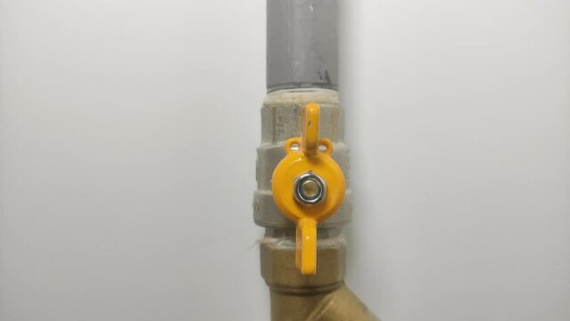 Master gasman closes the valve on the gas cock