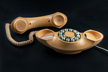 Peach coloured 1970's Modern telephone handset.