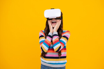 Amazed teenager. Shocked young girl in virtual reality helmet, VR reality. Isolated in studio,...