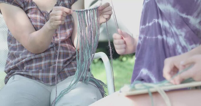 Two teenage girls make macram&eacute;